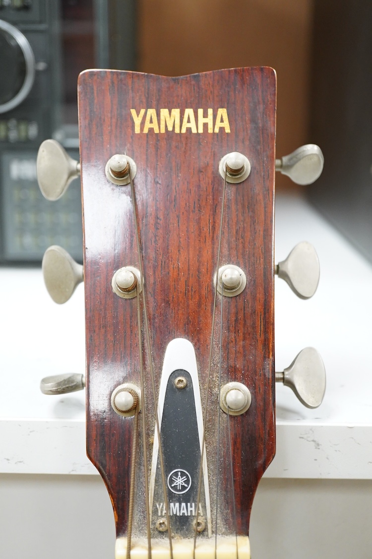 A Yamaha FG-180 acoustic steel string guitar